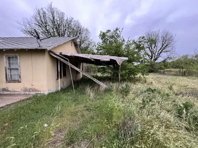 a backyard of a house with lots of green space