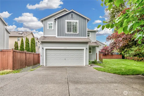 a front view of a house with a yard and garage