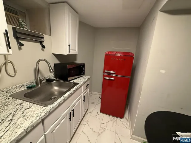 a kitchen with a sink stove and refrigerator