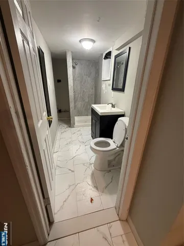 a bathroom with a sink and mirror with toilet