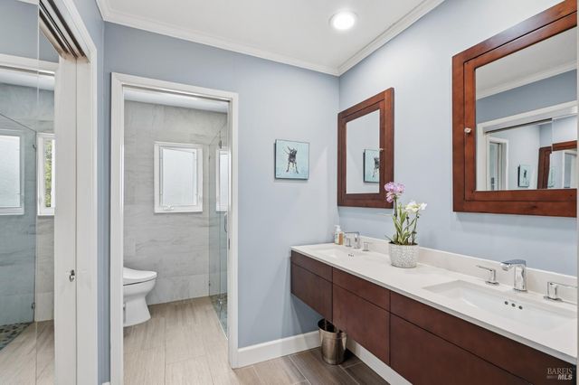a bathroom with a toilet sink and mirror