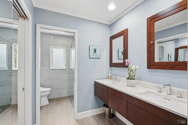 a bathroom with a toilet sink and mirror