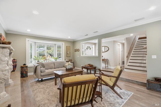 a dining room with furniture a chandelier and wooden floor