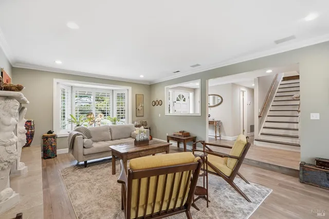 a dining room with furniture a chandelier and wooden floor
