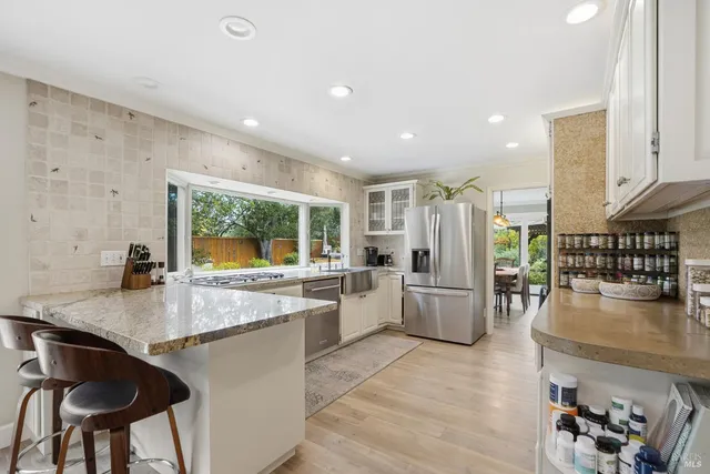 a view of a house with backyard sitting area and garden