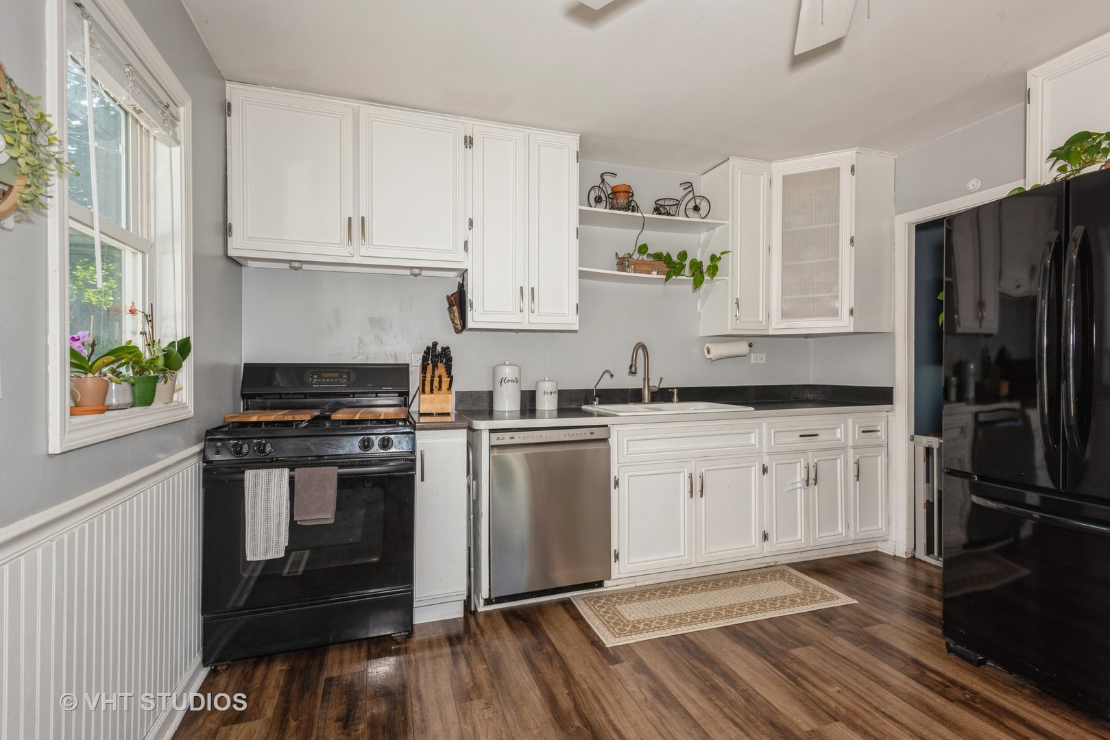 16 East Oltendorf Road Streamwood, IL 60107 - Photo 11 of 18 a kitchen with a stove white cabinetry and a refrigerator