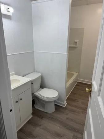 a bathroom with a toilet and a shower