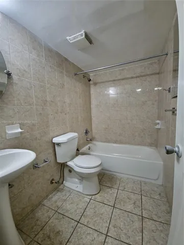a bathroom with a toilet a sink and bathtub