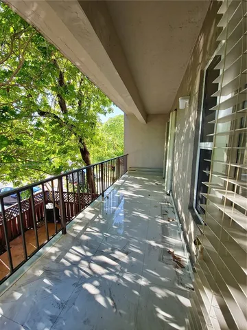 a view of balcony with wooden floor