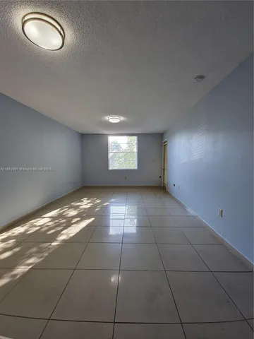 a view of an empty room with windows