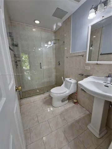 a bathroom with a sink toilet and shower