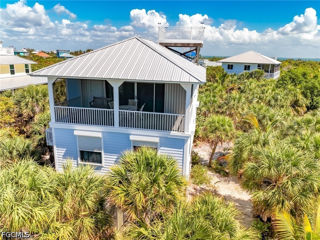 4510 Oyster Shell Drive Upper Captiva, FL 33924 - Photo 11 of 50 a front view of a house with a yard