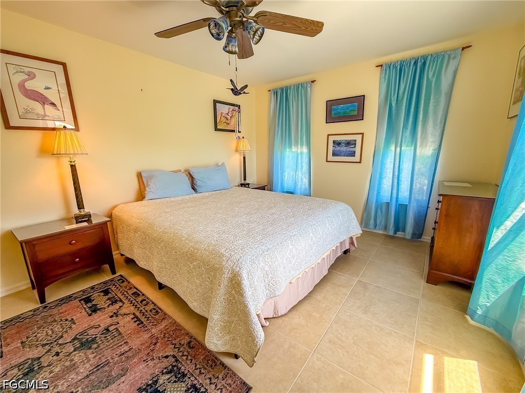 4510 Oyster Shell Drive Upper Captiva, FL 33924 - Photo 35 of 50 a bedroom with a bed and painting on the wall