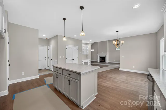 a large kitchen with stainless steel appliances a large center island in it