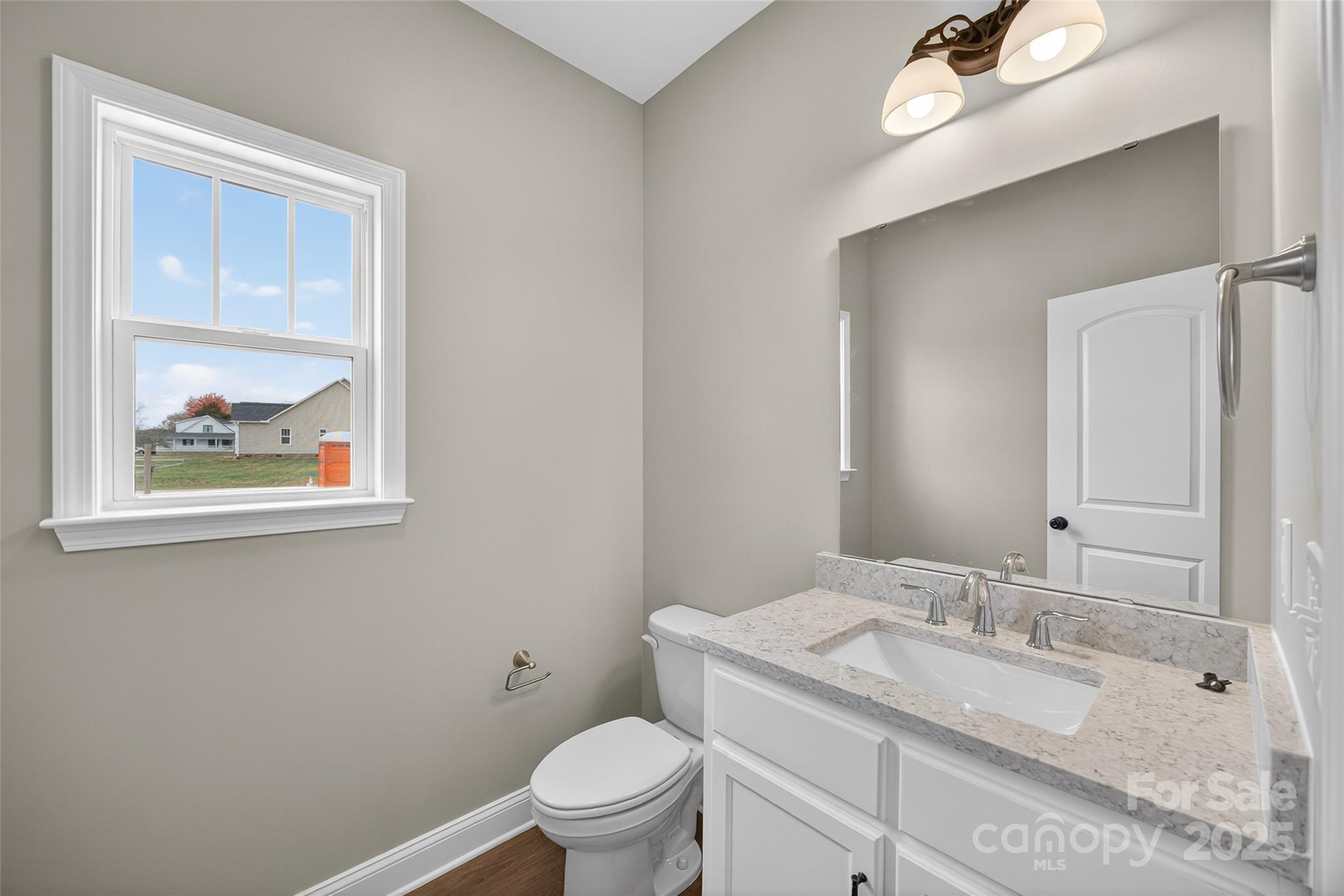 7195 Mooresville Road Salisbury, NC 28147 - Photo 17 of 38 a bathroom with a granite countertop toilet a sink and mirror