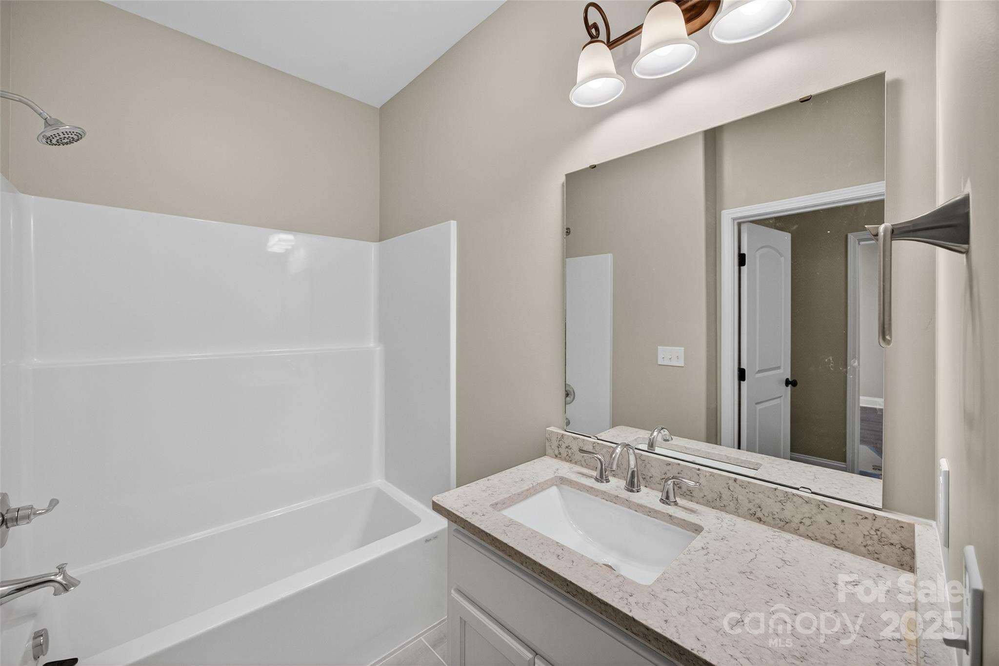 7195 Mooresville Road Salisbury, NC 28147 - Photo 23 of 38 a bathroom with a granite countertop bathtub sink vanity and mirror
