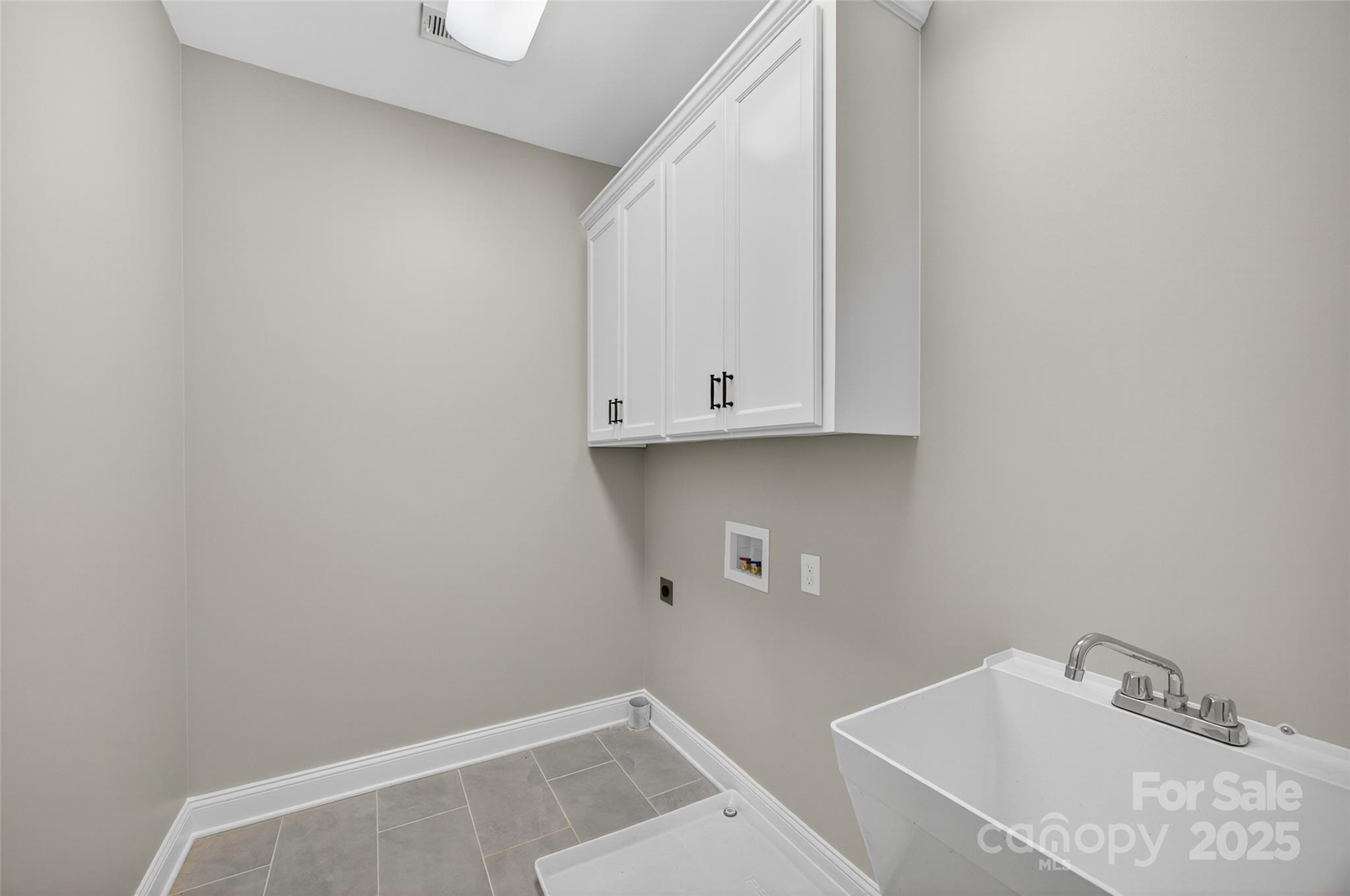 7195 Mooresville Road Salisbury, NC 28147 - Photo 27 of 38 a bathroom with a sink and cabinets