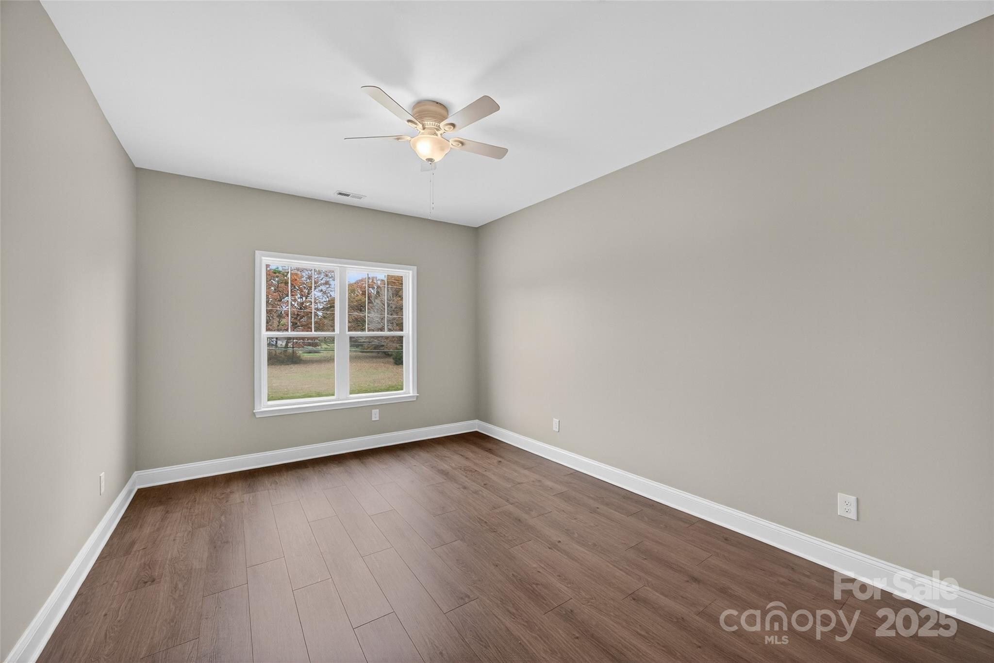 7195 Mooresville Road Salisbury, NC 28147 - Photo 28 of 38 a view of an empty room with wooden floor and a window