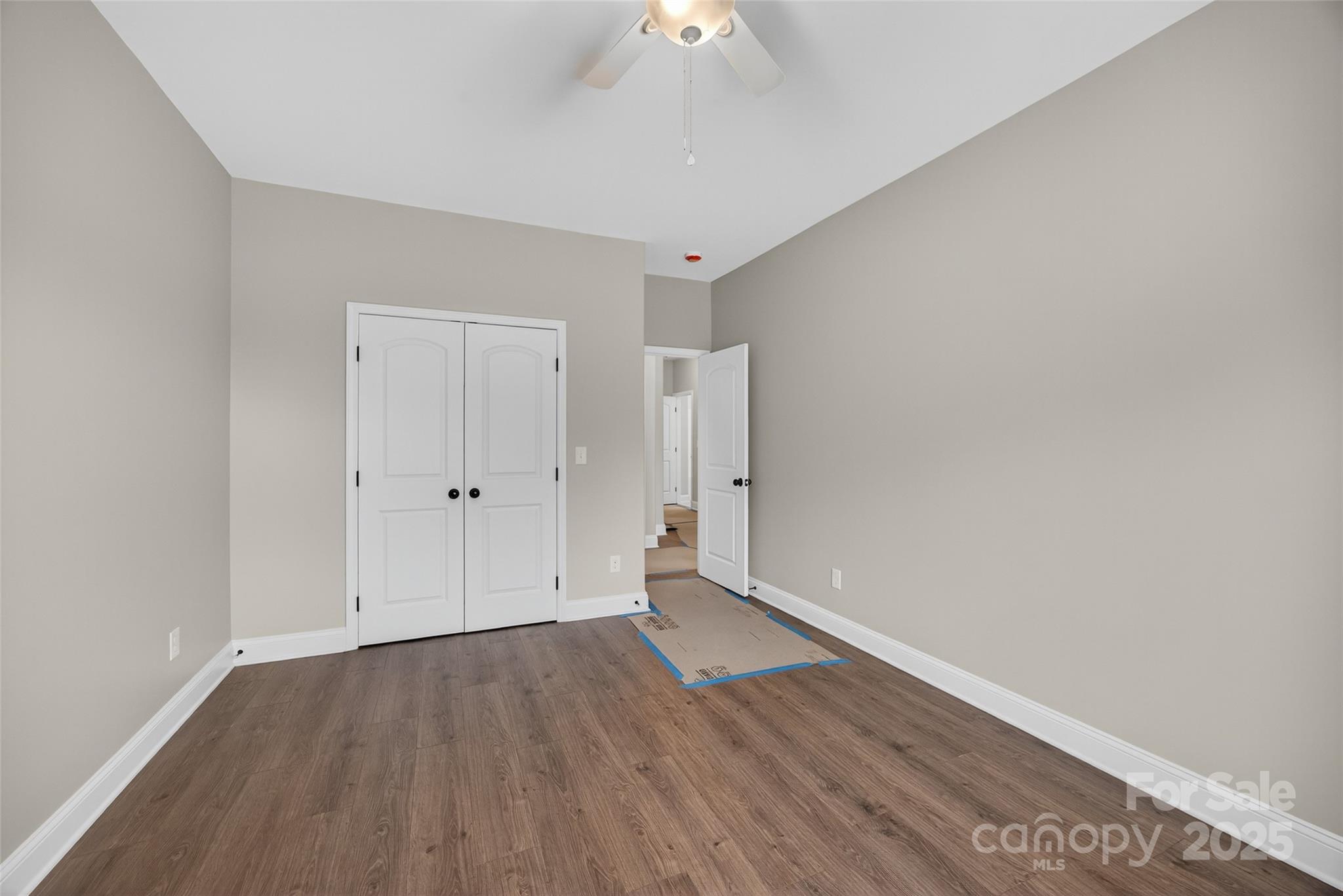 7195 Mooresville Road Salisbury, NC 28147 - Photo 29 of 38 a view of an empty room with wooden floor a ceiling fan and window