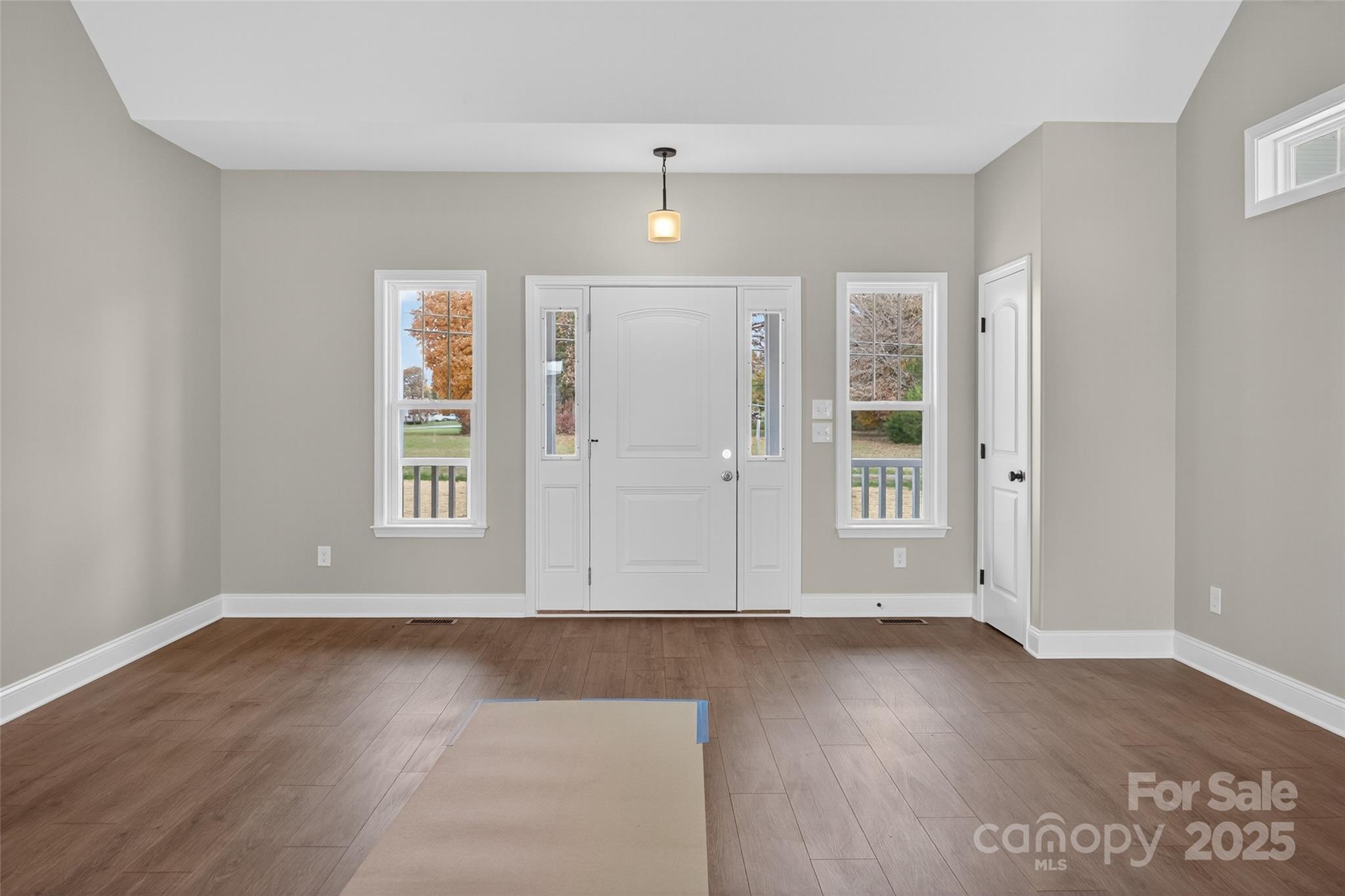 7195 Mooresville Road Salisbury, NC 28147 - Photo 7 of 38 an empty room with wooden floor and windows