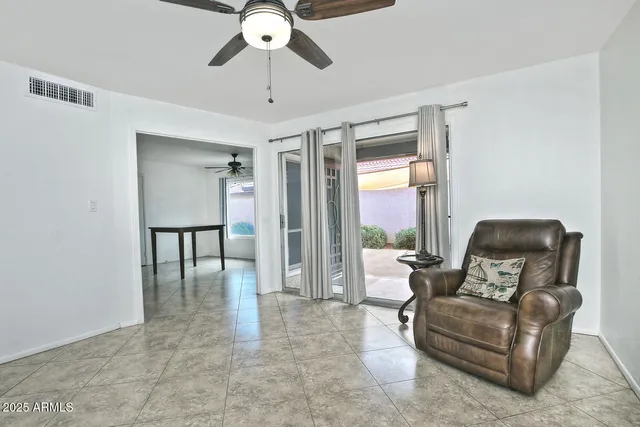 a living room with furniture and a large window