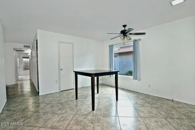 a view of room with a sink and a chandelier fan