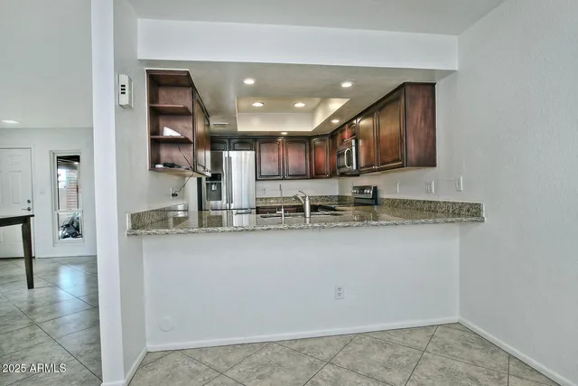 a kitchen with stainless steel appliances granite countertop a sink and a stove
