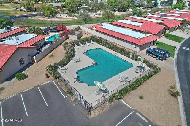 an aerial view of a house with a garden and deck