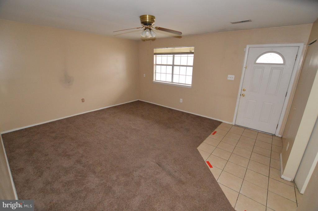 7972 Tick Neck Road Pasadena, MD 21122 - Photo 2 of 19 an empty room with windows and closet