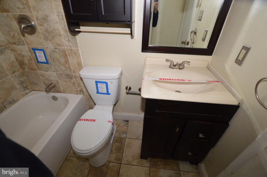 7972 Tick Neck Road Pasadena, MD 21122 - Photo 12 of 19 a bathroom with a sink toilet and mirror