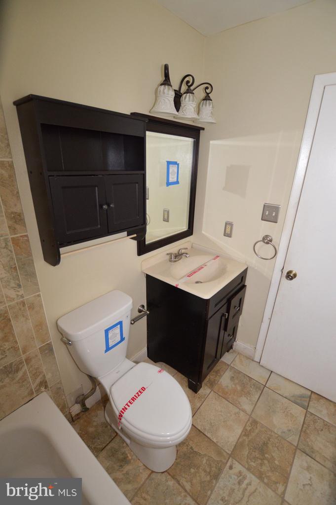 7972 Tick Neck Road Pasadena, MD 21122 - Photo 15 of 19 a bathroom with a sink vanity and toilet