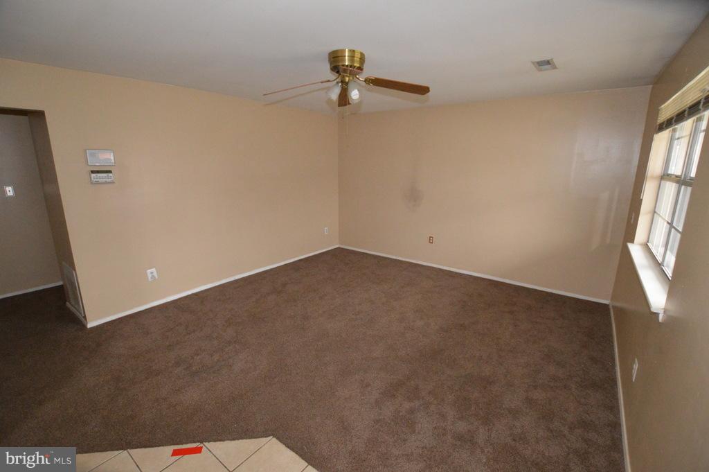 7972 Tick Neck Road Pasadena, MD 21122 - Photo 3 of 19 a view of an empty room with a window