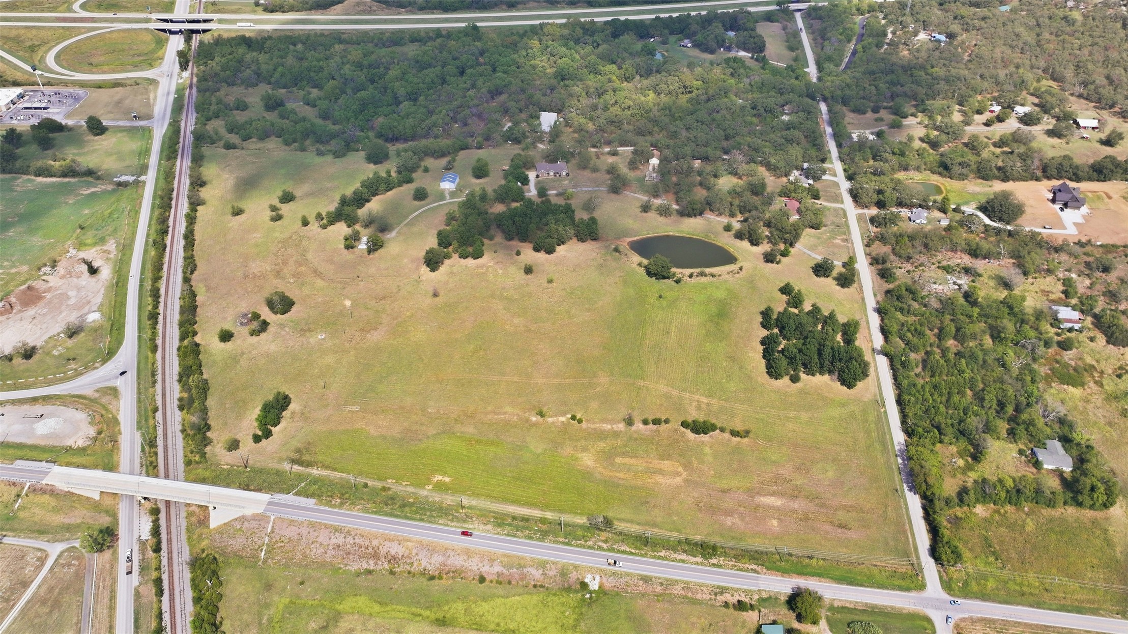 17875 East 589 Road Inola, OK 74036 - Photo 36 of 73 Expansive acreage featuring a natural pond, scattered mature trees.