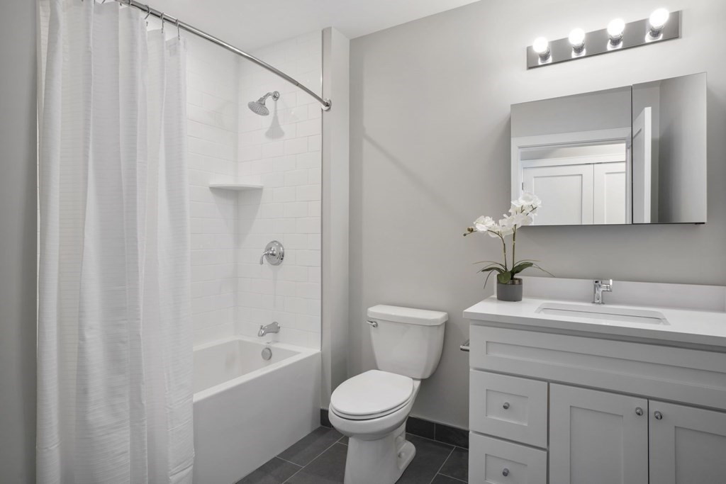 610 Rutherford Avenue, Unit 306 Boston, MA 02129 - Photo 4 of 10 a bathroom with a sink toilet vanity and shower