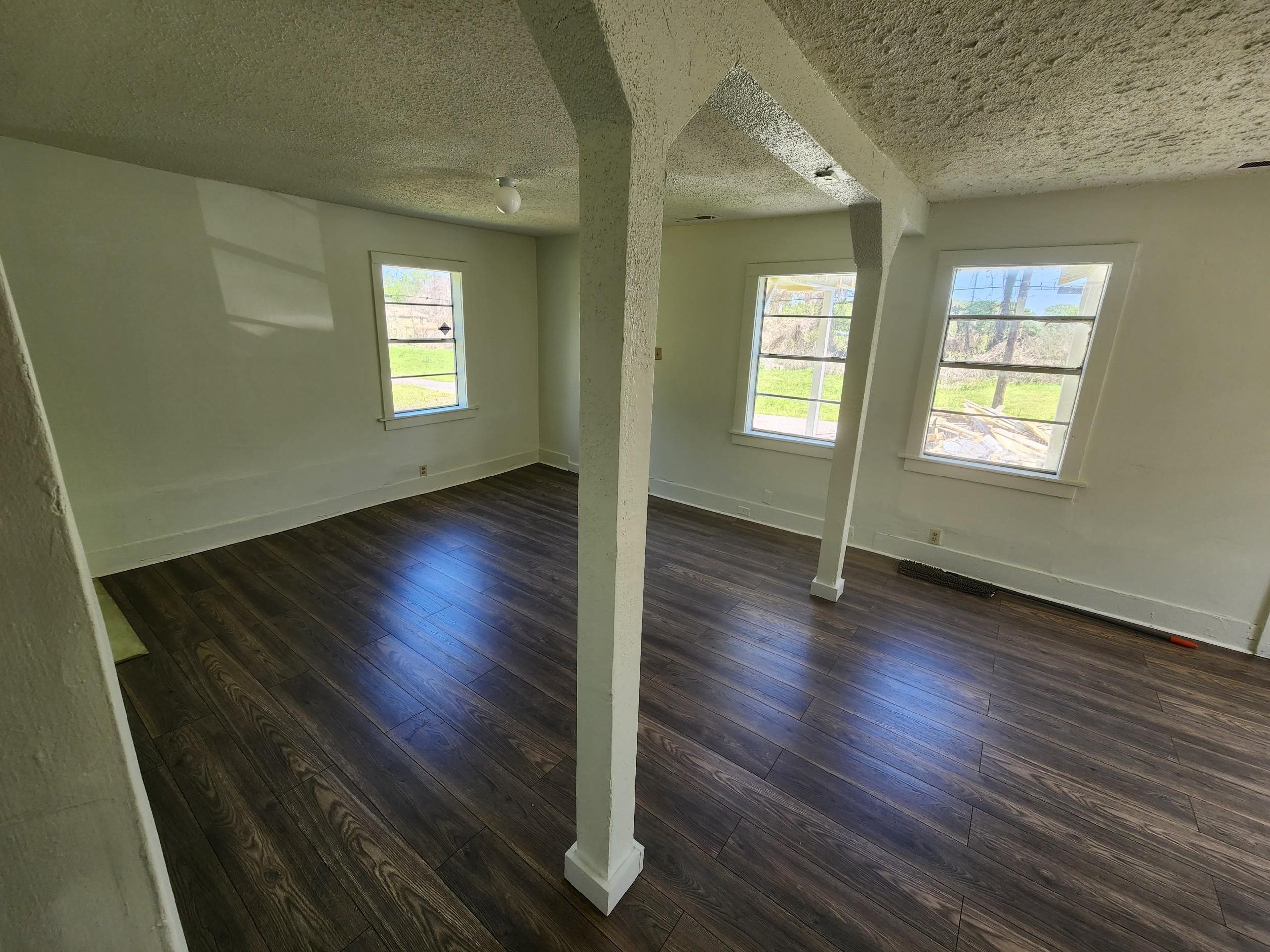 1393 Michigan Street Memphis, TN 38106 - Photo 12 of 27 an empty room with wooden floor and windows