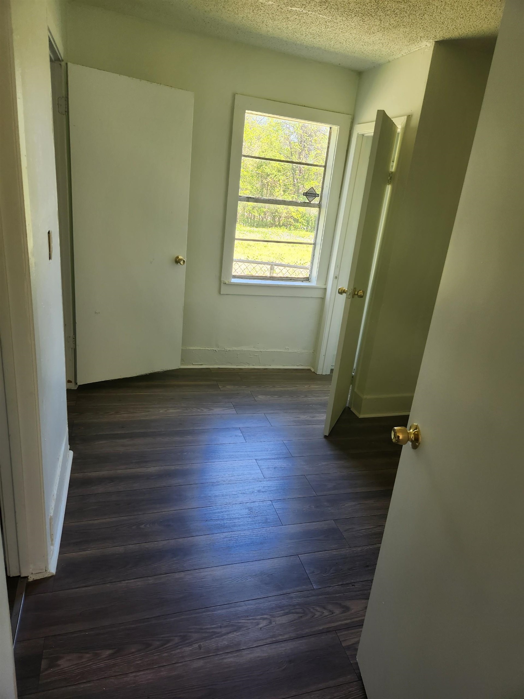 1393 Michigan Street Memphis, TN 38106 - Photo 13 of 27 a view of an empty room with wooden floor and a window