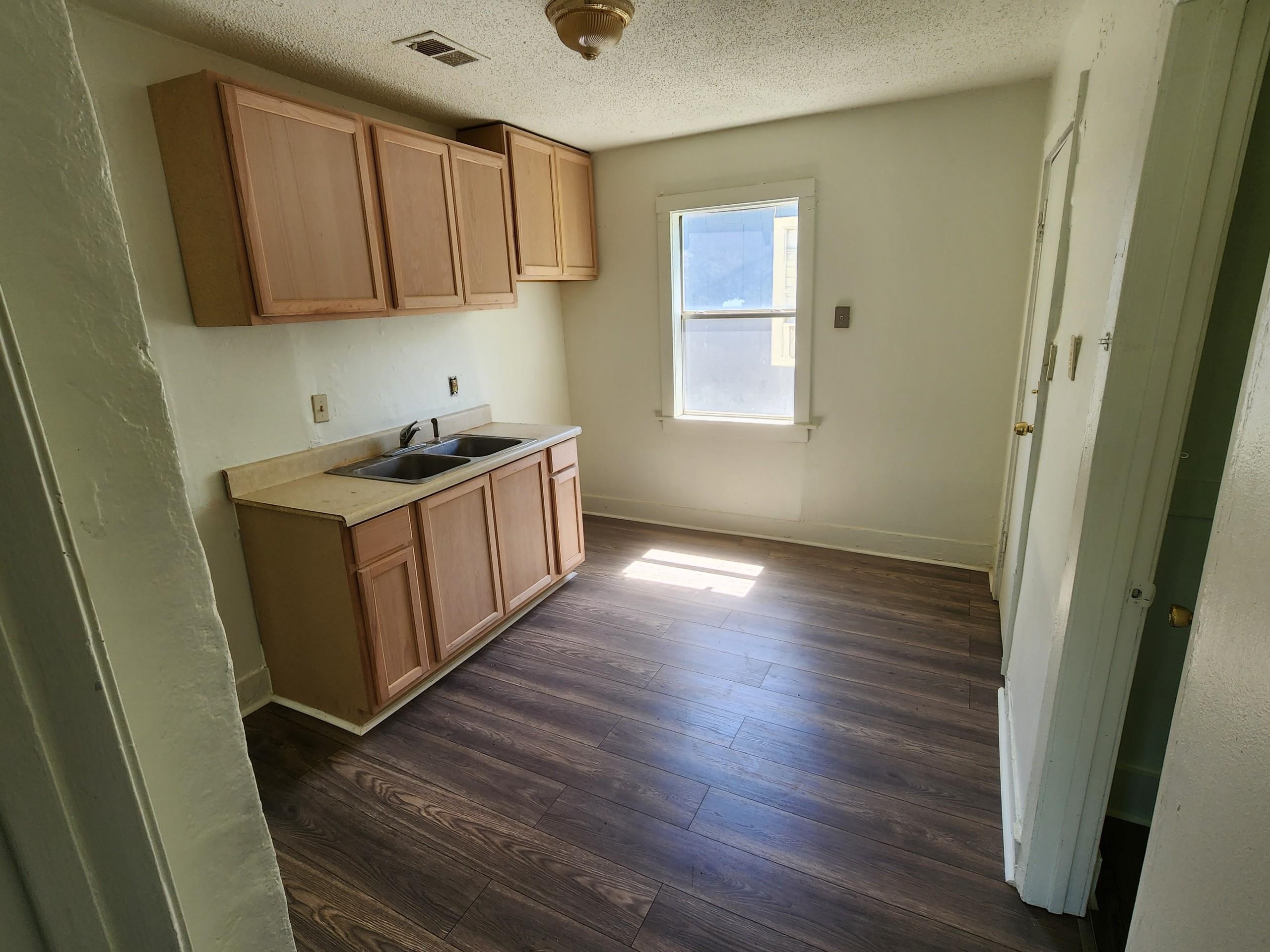 1393 Michigan Street Memphis, TN 38106 - Photo 17 of 27 a kitchen with wooden floors and sink