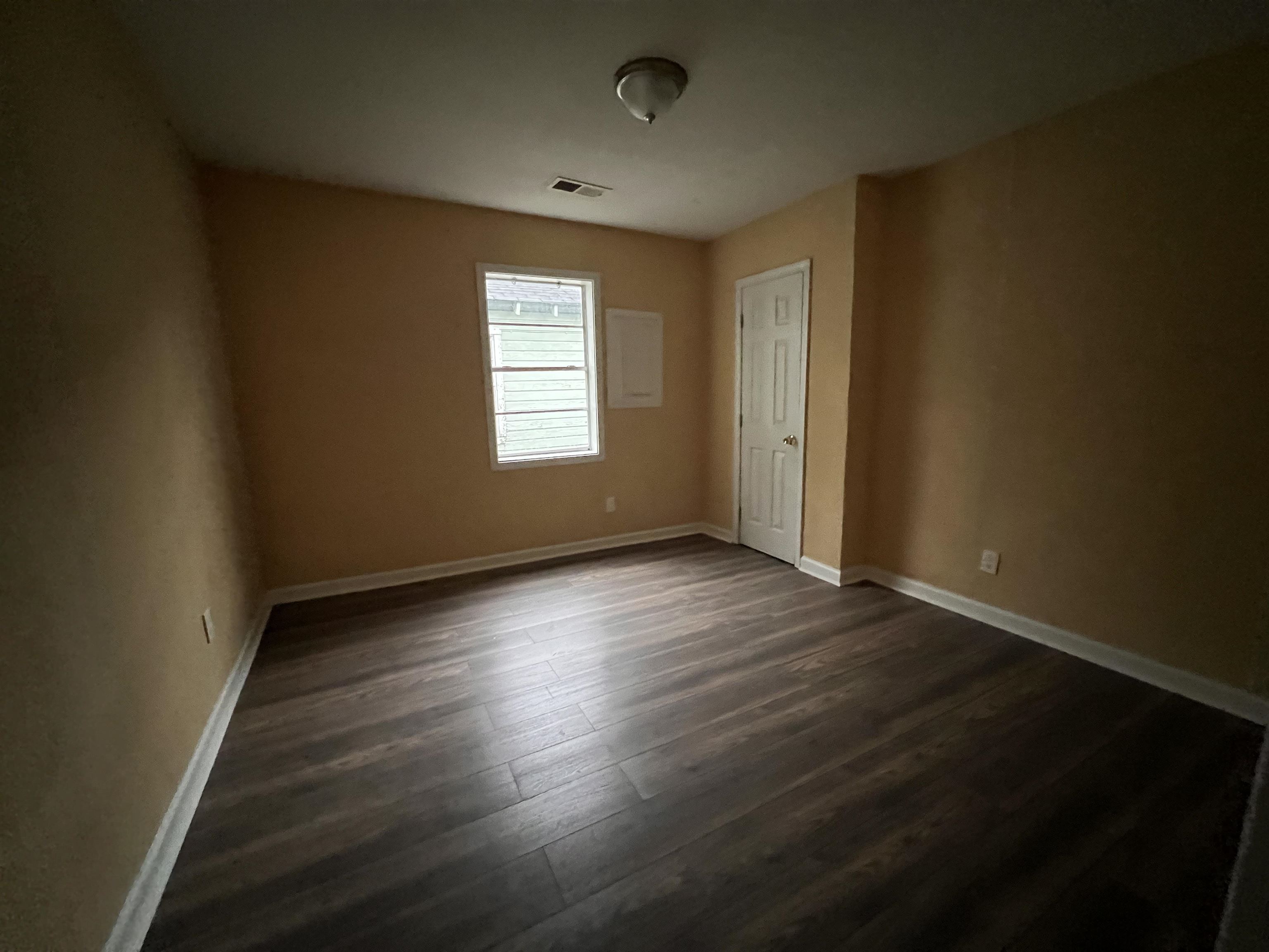 1393 Michigan Street Memphis, TN 38106 - Photo 22 of 27 an empty room with wooden floor and windows