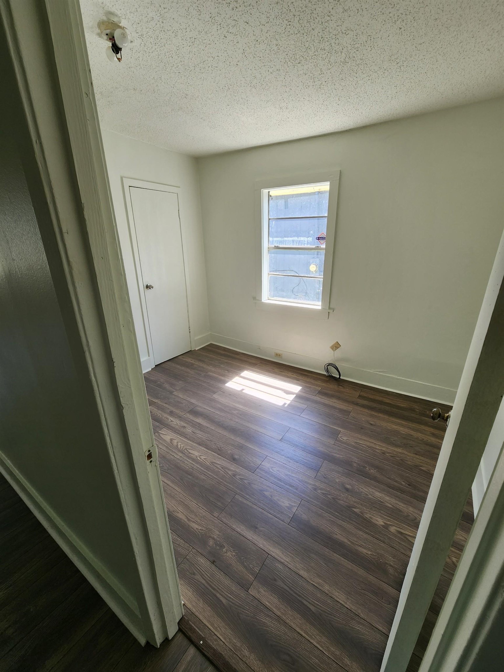 1393 Michigan Street Memphis, TN 38106 - Photo 4 of 27 a view of an empty room with wooden floor and a window