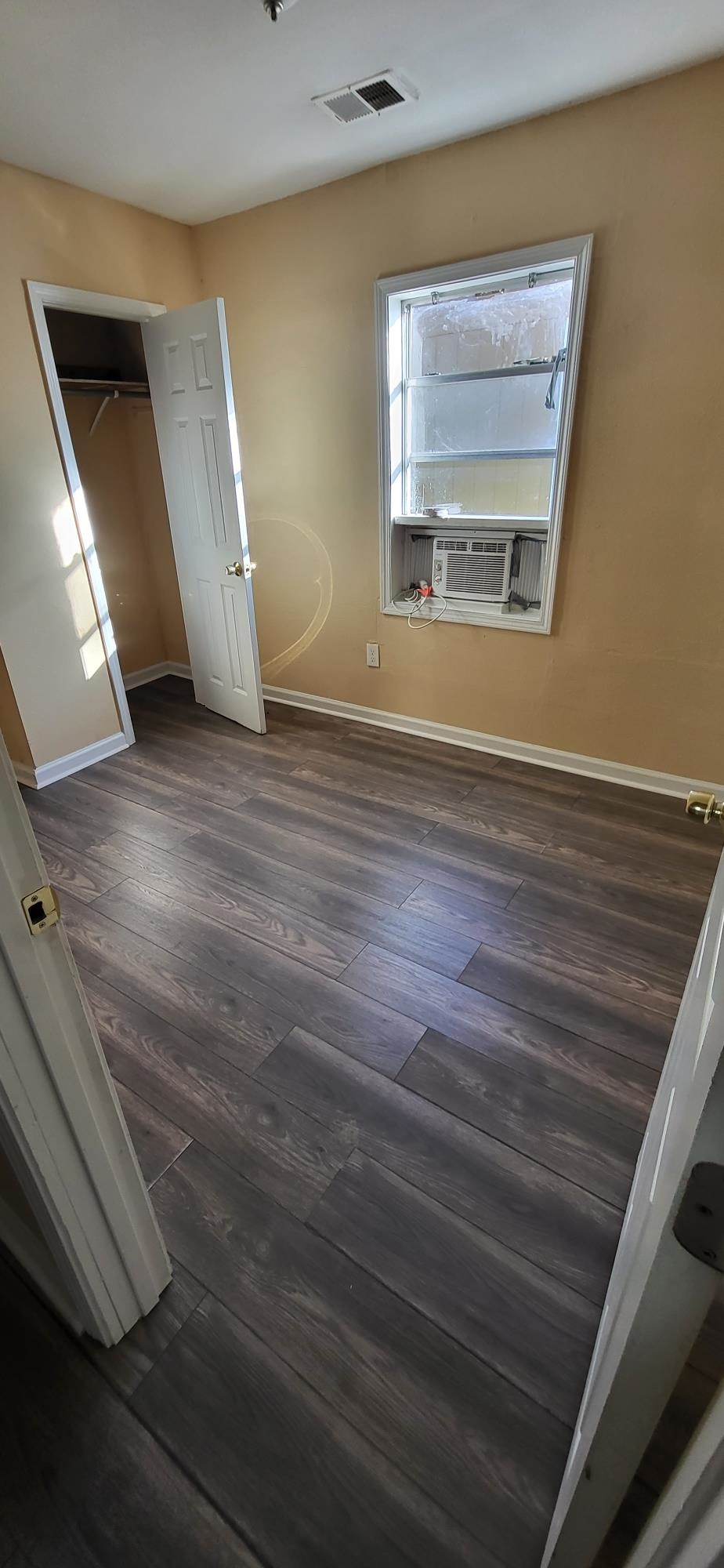1393 Michigan Street Memphis, TN 38106 - Photo 7 of 27 a view of an empty room with wooden floor and a window
