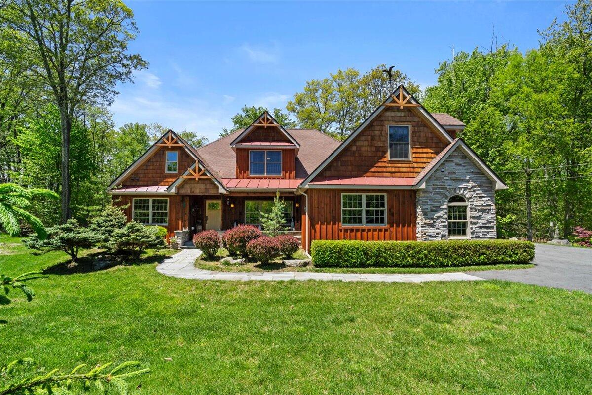 a front view of a house with a yard and porch