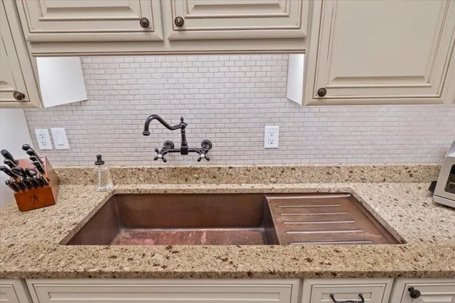 a reading room with furniture a large window and wooden floor