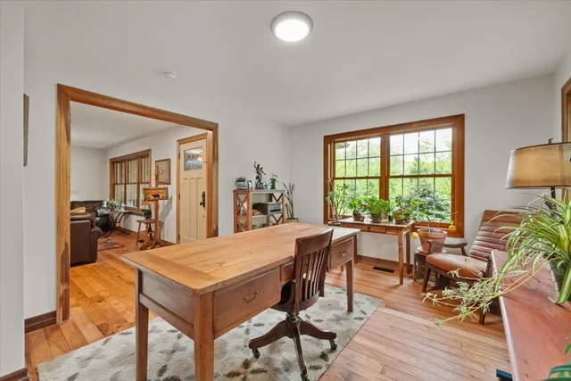 a bathroom with a sink a toilet a window and vanity