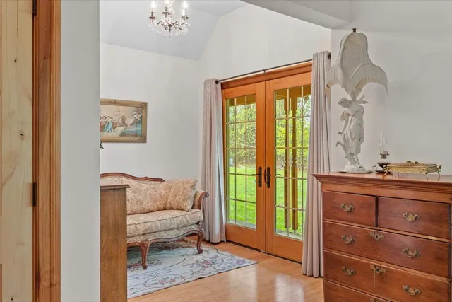 a bedroom with a couch and ceiling fan