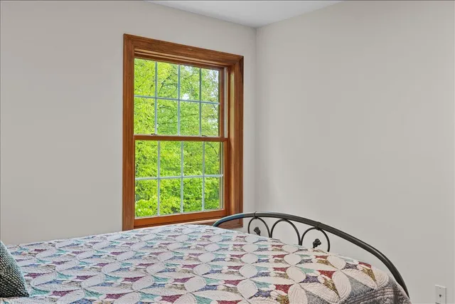 a view of a house next to a yard with big trees