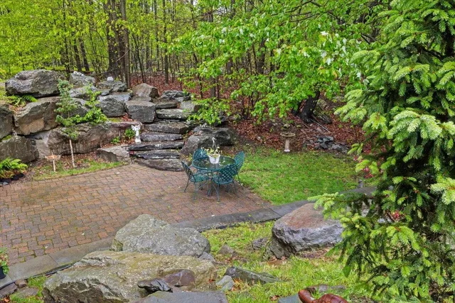 a view of a garden with a building in the background