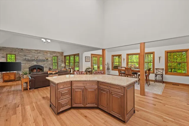 a large kitchen with kitchen island granite countertop a sink and cabinets