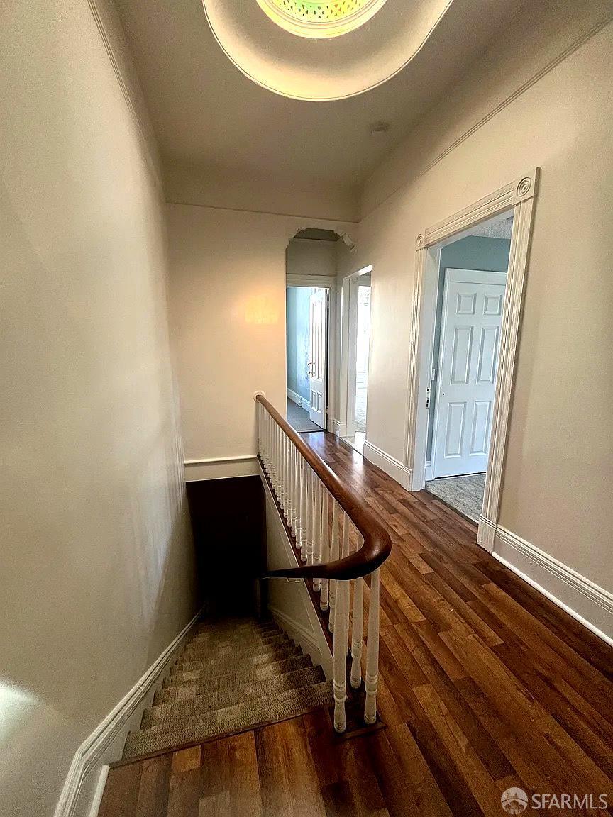 3173 21st Street San Francisco, CA 94110 - Photo 11 of 21 a view of a hallway with wooden floor and staircase