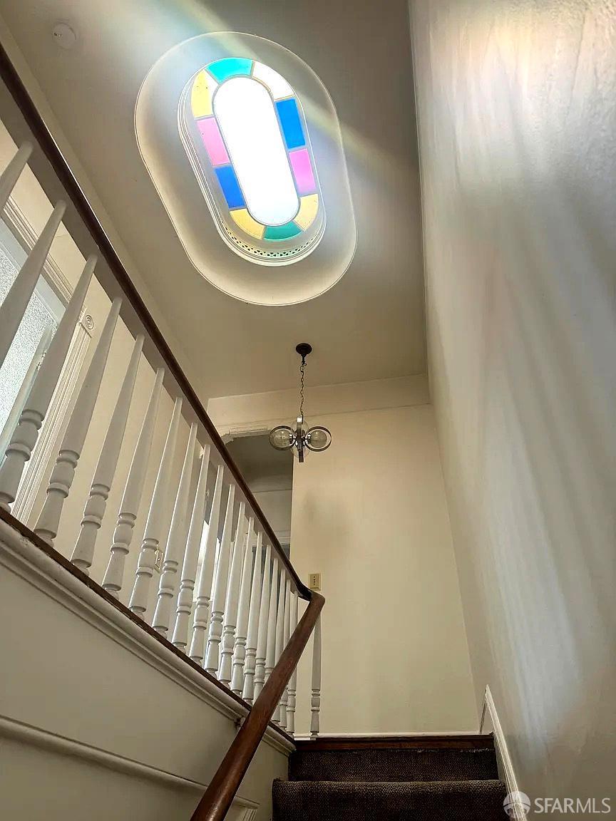 3173 21st Street San Francisco, CA 94110 - Photo 9 of 21 a view of staircase with railing and a window