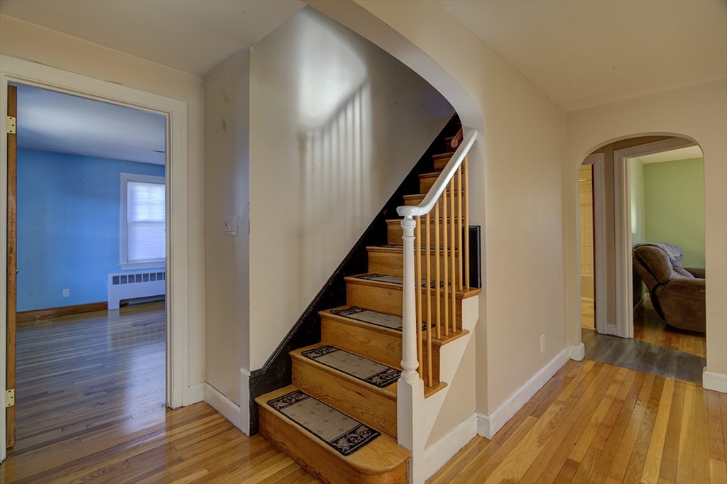 29 Perley Street Lynn, MA 01905 - Photo 11 of 27 a view of a hallway with wooden floor and staircase